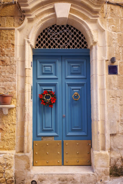 istock Blue wooden front door decorated with Christmas wreath 1449180601