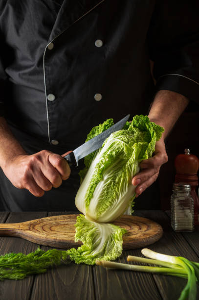 istock Napa cabbage salad preparation. Chef while working in the restaurant kitchen. Diet breakfast or dinner idea 1449181407