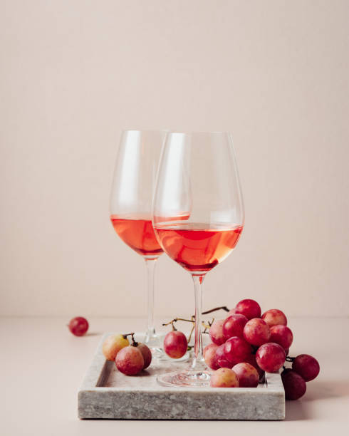 istock Two glasses of rose wine and red grapes. 1449181895