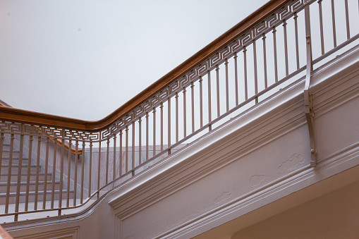 Wood staircase inside contemporary white modern house