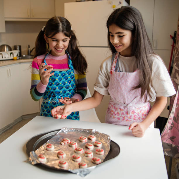 istock Middle eastern young girls making festive cookies. 1449189163
