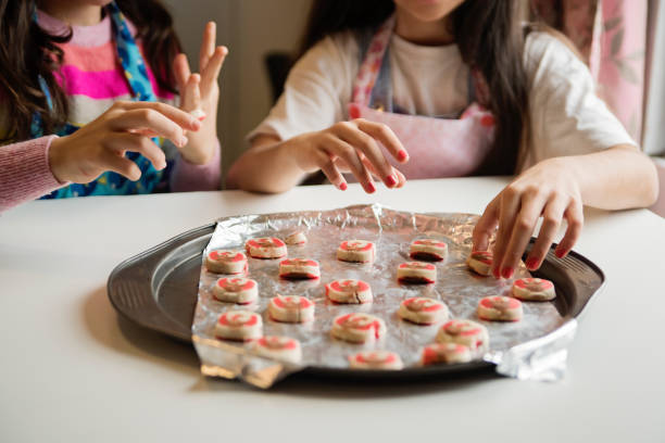 istock Middle eastern young girls making festive cookies. 1449189191
