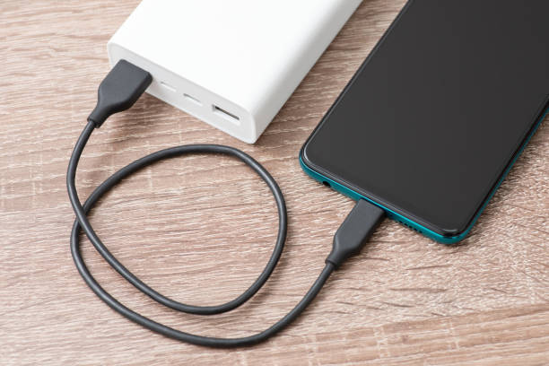 istock Smartphone battery charging with power bank. close-up 1449189198