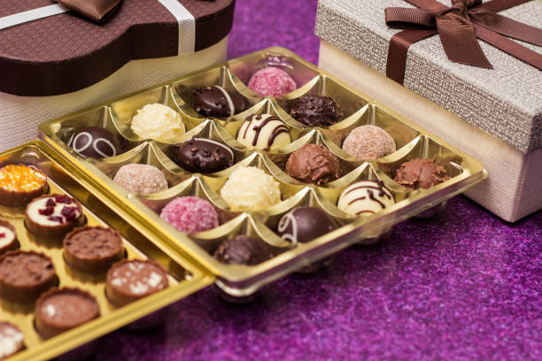 istock Box with delicious chocolate candies and heart shape gift 1449190380