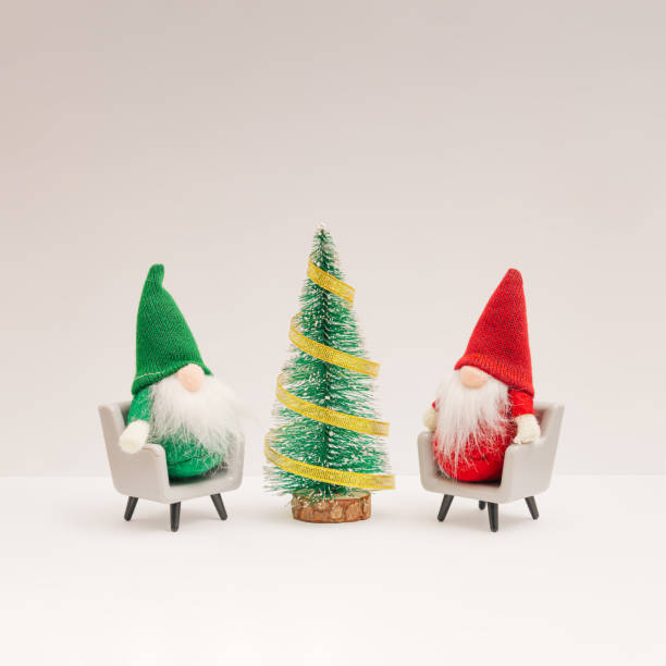 Four joyful colored dwarfs made of plasticine. There is a fairy and a snowman in the background.