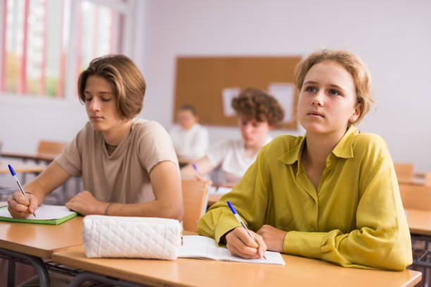 istock Group of school kids and teacher during lesson 1449192275
