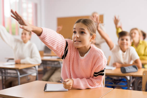 istock Students raise their hand to answer during lesson in class 1449192298