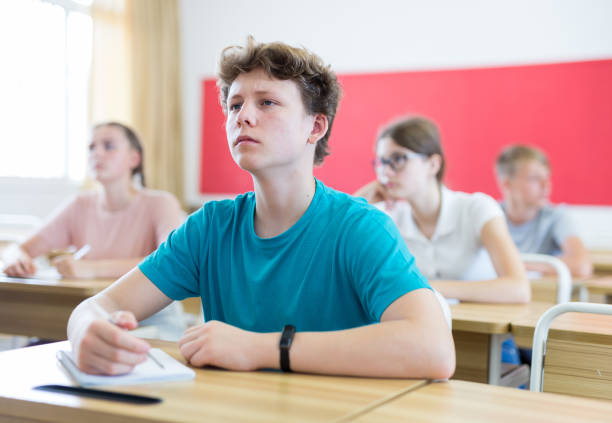 istock Pupils sitting in class and listening 1449192529