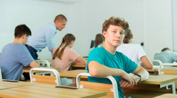 istock Portrait of young guy student in audience, looking at camera 1449192686