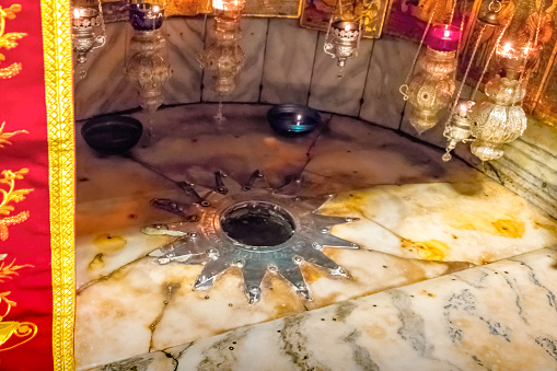 Grotto of the Nativity, fourteen-point silver star marking the traditional spot of Jesus' birth in the Church of the Nativity, Bethlehem, Palestine, Israel.