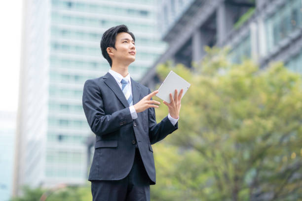 istock Businessman with tablet in business district 1449200861