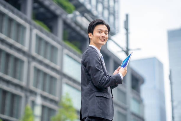 istock Businessman with tablet in business district 1449201422
