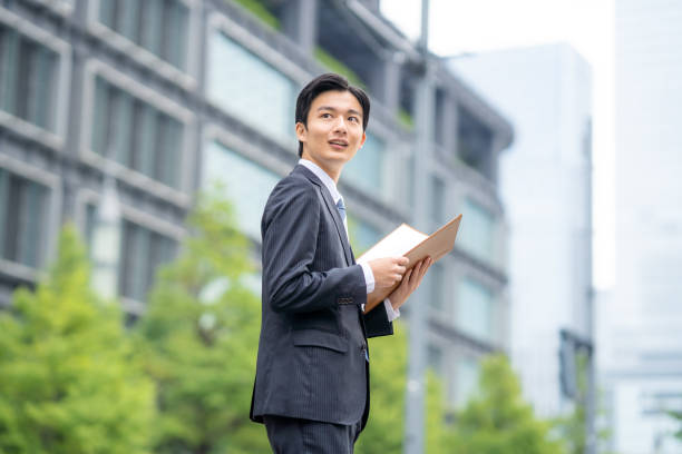 istock Businessman with file in business district 1449201601