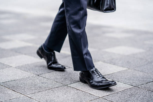 Leather shoes of a walking businessman stock photo