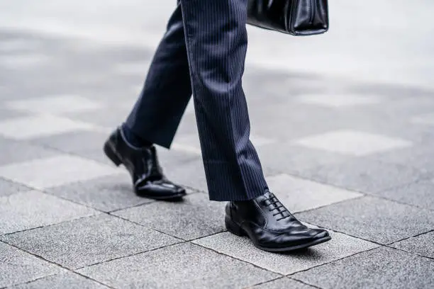 Photo of Leather shoes of a walking businessman