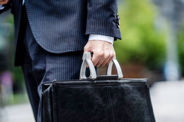 istock Hand of a man with a business bag 1449201783