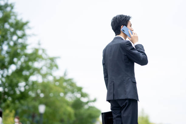istock Businessman making a phone call in the business district 1449202473