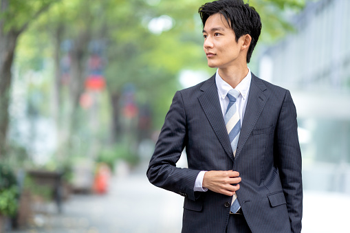 A man in a suit walking in the business district