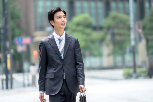 istock A man in a suit walking in the business district 1449205194
