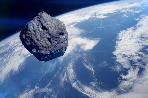 Planet Earth and big asteroid in the space. Asteroid in outer space near Earth planet. Meteorite on orbit of Earth. Ice meteor is solar system. Elements of this image furnished by NASA. ______ Url(s): https://images.nasa.gov/details-iss040e083890.html