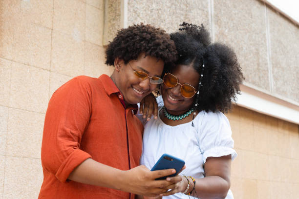 istock Friends In The City Using Cell Phone 1449205933