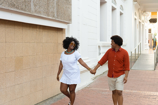 Black couple strolling in the street