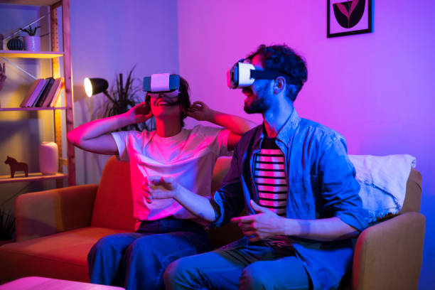 istock Portrait of a young couple using VR headsets and having fun 1449207403