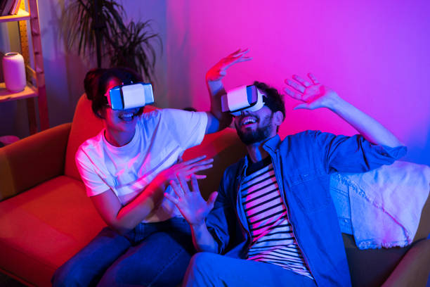istock Young couple playing VR games and having fun at home 1449207407
