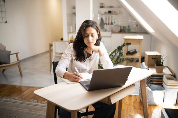 istock Portrait of a young freelancer working from her home office 1449207532