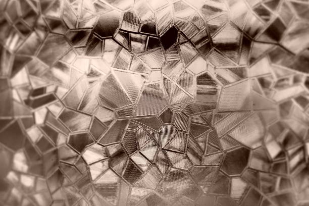 istock Embossed glass background. Corrugated glass sepia monochrome. Refraction of light in a bumpy transparent surface under backlight. The play of highlights. Black brown areas. Abstract background 1449207638