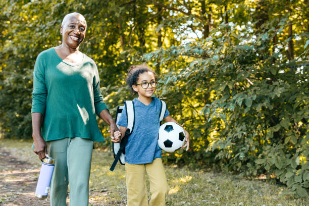 istock Student girl walking with grandmother from school 1449208270