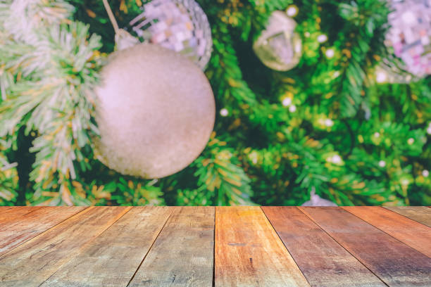 istock Empty wood table top with blur Christmas tree with bokeh light background 1449208332