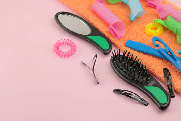 istock Various hair accessories, curlers, combs, barrettes and elastic bands. on a bright pink background. top view with space for text 1449208670