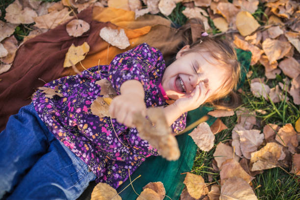 istock Lovely kid lying on Autumn foliage 1449208866