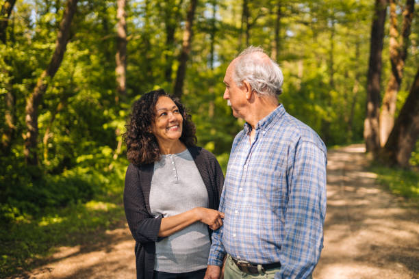 istock Senior Heterosexual  Couple Walking in the Woods While Talking 1449210911