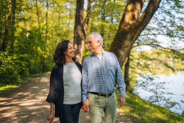 Charming Retired Couple Walking Around a Lake
