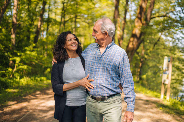 istock Golden Age Couple Walking in the City Park  While Talking 1449210914