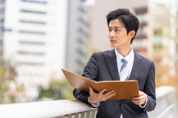 istock Businessman with file in business district 1449215241