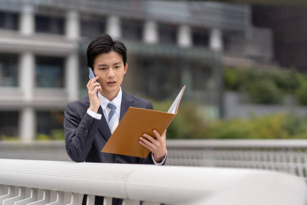 istock Businessman with file in business district 1449215737