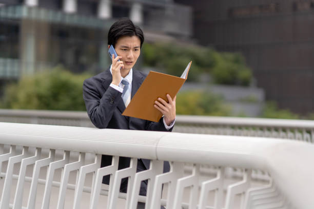 istock Businessman with file in business district 1449215770