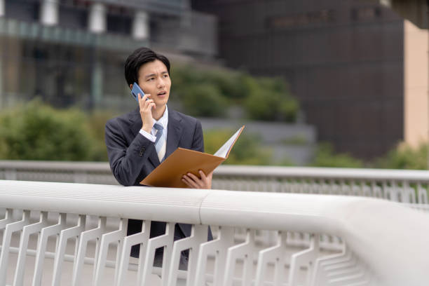 istock Businessman with file in business district 1449215771