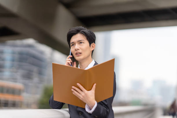 istock Businessman with file in business district 1449215846