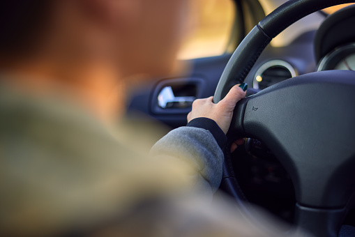 Blurred image of a woman driving a car. High quality photo