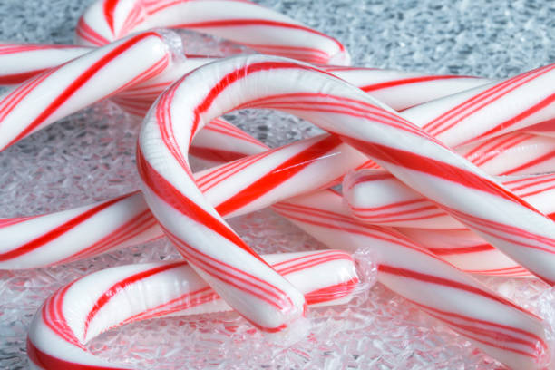 Peppermint Candy Canes on a Frosted Texture Surface stock photo