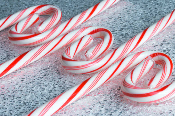 Peppermint Candy Canes on a Frosted Texture Surface stock photo