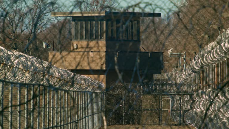 Prison guard tower with barb wire fence