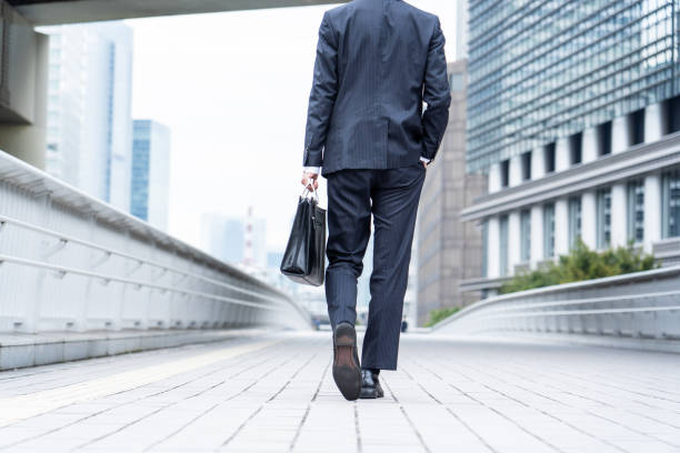 istock A man in a suit walking in the business district 1449220773