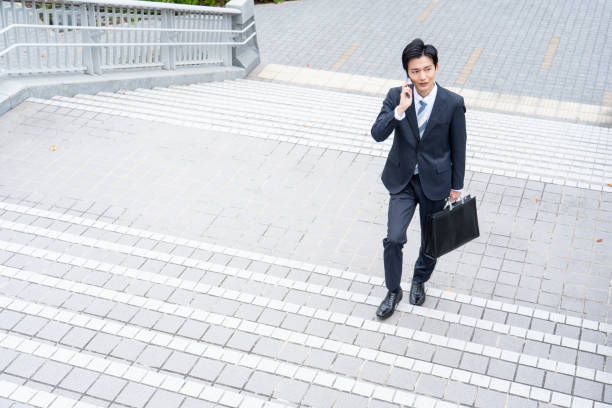 istock A man in a suit walking in the business district 1449220792