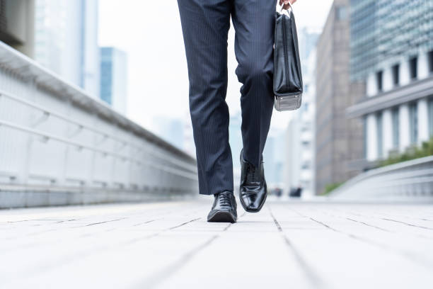 istock A man in a suit walking in the business district 1449220825