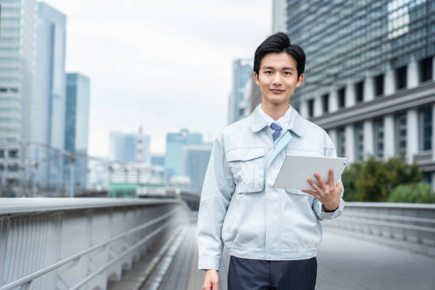 Men in work clothes posing in business district stock photo
